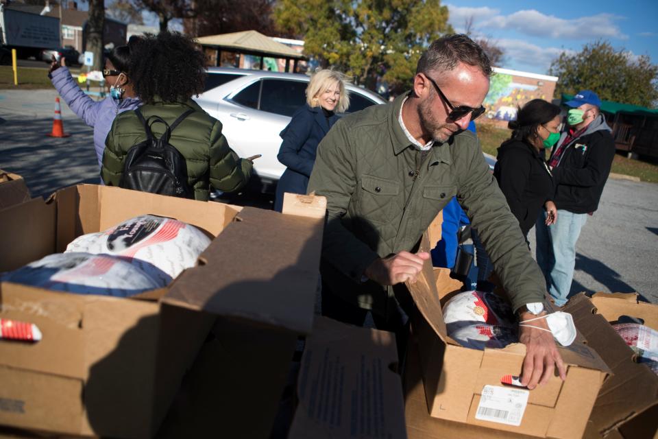 Volunteers hand out turkeys at Kingswood Community Center Friday, Nov. 19, 2021.