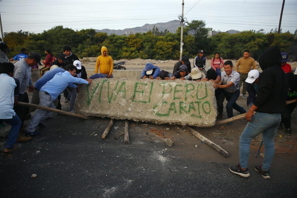 Supporters of ousted Peruvian President Pedro Castillo block the Pan-American North Highway to protest his detention in Viru, Peru, Thursday, Dec. 15, 2022. Peru's new government declared a 30-day national emergency on Wednesday amid violent protests following Castillo's ouster, suspending the rights of "personal security and freedom" across the Andean nation. (AP Photo/Hugo Curotto)