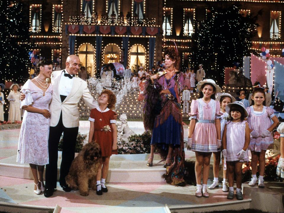 Albert Finney, Aileen Quinn, Carol Burnett and others on stage in scene from the film 'Annie', 1982