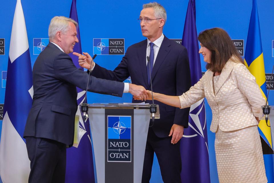 Finland's Foreign Minister Pekka Haavisto, left, Sweden's Foreign Minister Ann Linde, right, and NATO Secretary General Jens Stoltenberg attend a media conference after the signature of the NATO Accession Protocols for Finland and Sweden in the NATO headquarters in Brussels, July 5, 2022.