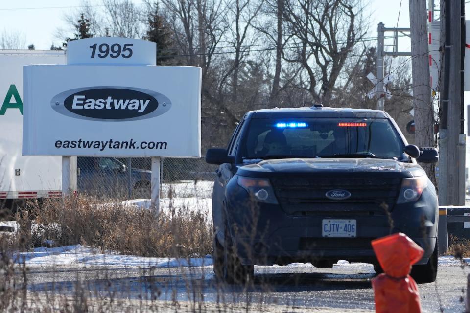 A police cruiser is shown at the entrance to the Eastway Tank company, the scene of an industrial explosion, in Ottawa, Friday, Jan.14, 2022. Ottawa police say one man has died and five others are missing after an explosion at an Ottawa tanker-truck manufacturer yesterday. THE CANADIAN PRESS/Sean Kilpatrick
