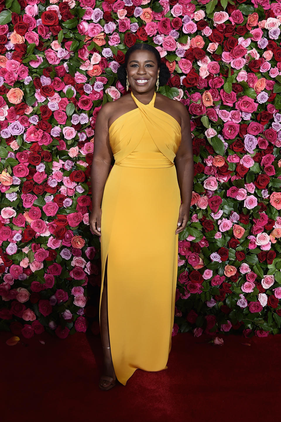 <p>Uzo Aduba wears a bright orange gown designed by Lorraine Schwartz. Source: Getty </p>