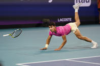 Carlos Alcaraz, of Spain, dives as he attempts to return a shot by Jannik Sinner, of Italy, during the Miami Open tennis tournament, Friday, March 31, 2023, in Miami Gardens, Fla. (AP Photo/Wilfredo Lee)