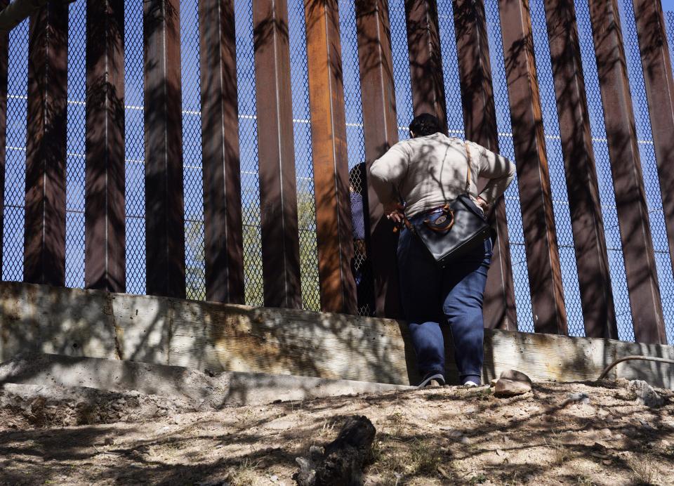 Women talking to her loved ones through the border fence from Nogales Sonora, Mexico in 2020. Families who are separated from deportation this is how they communicate.