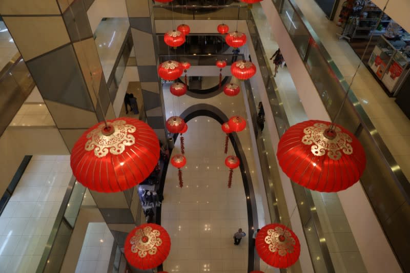 People walk thorugh a shopping mall in Singapore