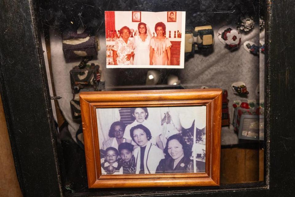 Photos show generations of Diana Garcia Rios’ family. The top photo is from Rios’ wedding day with her grandmother, Tomasa Alejandro, left, and her mother Lucia Alejandro Garcia, right. The bottom photo is from a Christmas family celebration in the 1950s with Rios’ grandmother Tomasa, biological mother Andrea, cousin Frank Alejandro Jr., brother Manuel Alejandro Garcia, mother Lucia, and aunt Amparo Rivera.