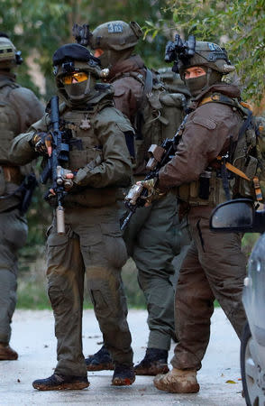 Members of Israeli armed forces are seen during a raid in the West Bank city of Jenin, January 18, 2018. REUTERS/Mohamad Torokman