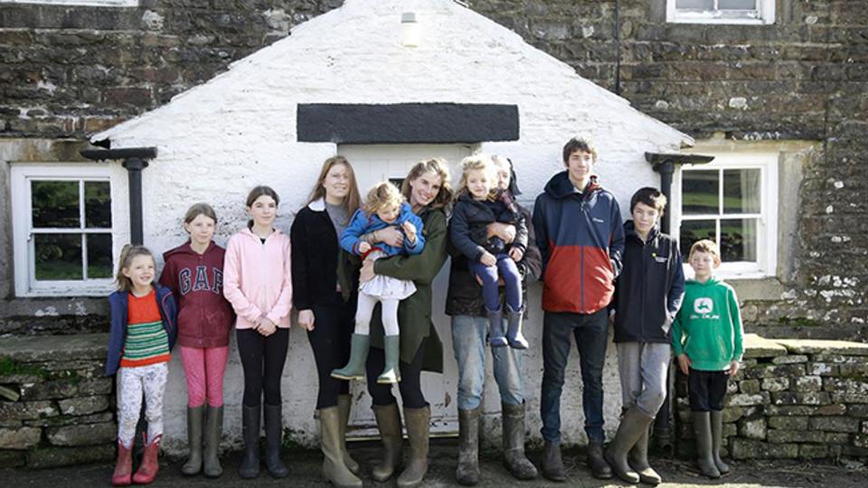 amanda owen family stand in front of house