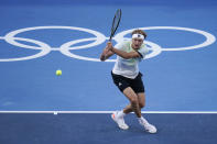 Alexander Zverev, of Germany, returns a shot to Karen Khachanov, of the Russian Olympic Committee, during the men's single gold medal match of the tennis competition at the 2020 Summer Olympics, Sunday, Aug. 1, 2021, in Tokyo, Japan. (AP Photo/Seth Wenig)
