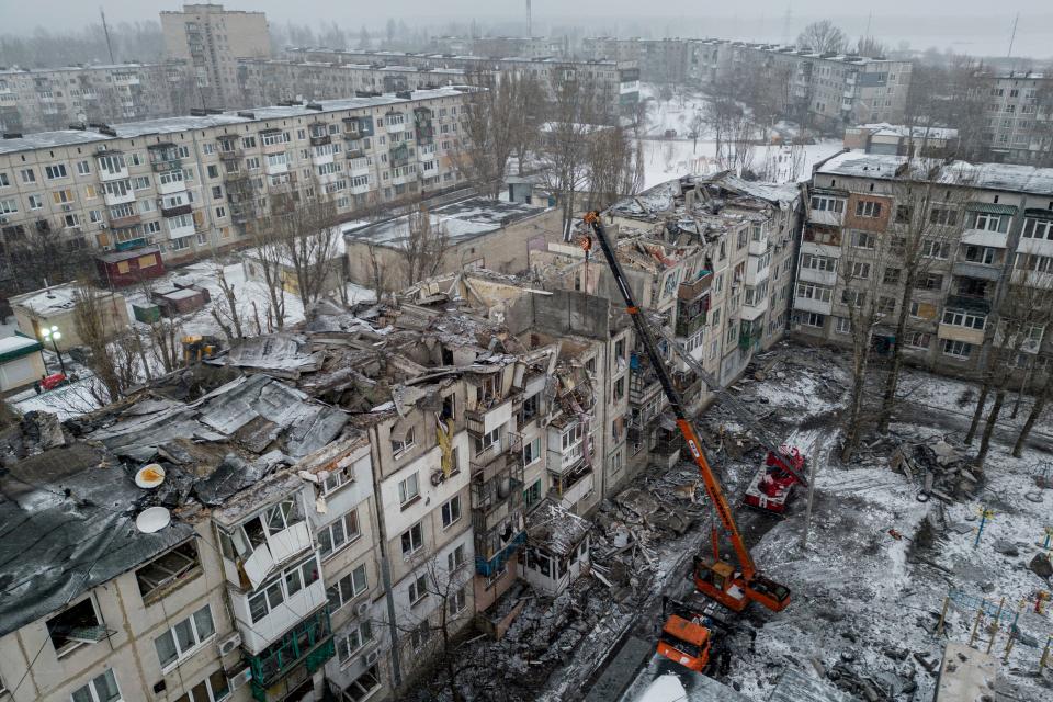 Rescue workers clear the rubble of the residential building which was destroyed by a Russian rocket in Pokrovsk, Ukraine, Wednesday, Feb. 15, 2023.