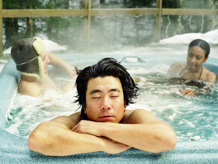 Three friends in a hot tub.