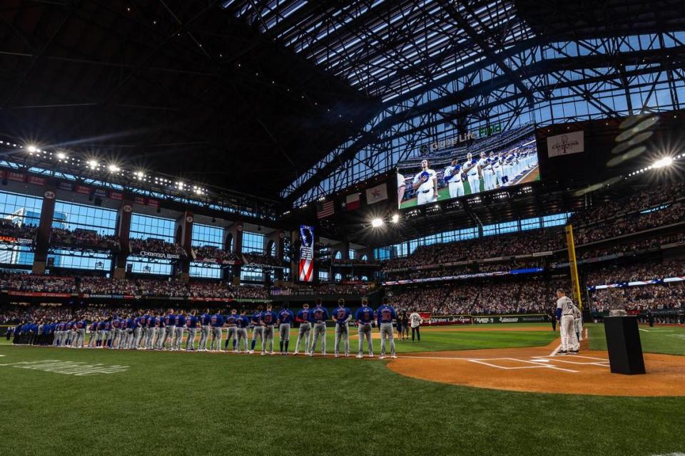 The Chicago Cubs and Texas Rangers line up while the National Anthem is performed prior to the season opener at Globe Life Field in Arlington on Thursday, March 28, 2024. Chris Torres/ctorres@star-telegram.com