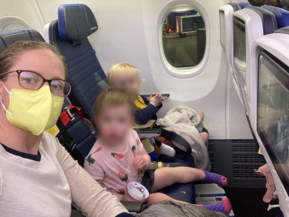 Hamilton and her two daughters on the return flight from Disneyworld, where her two infant daughters can sit upright on their own.