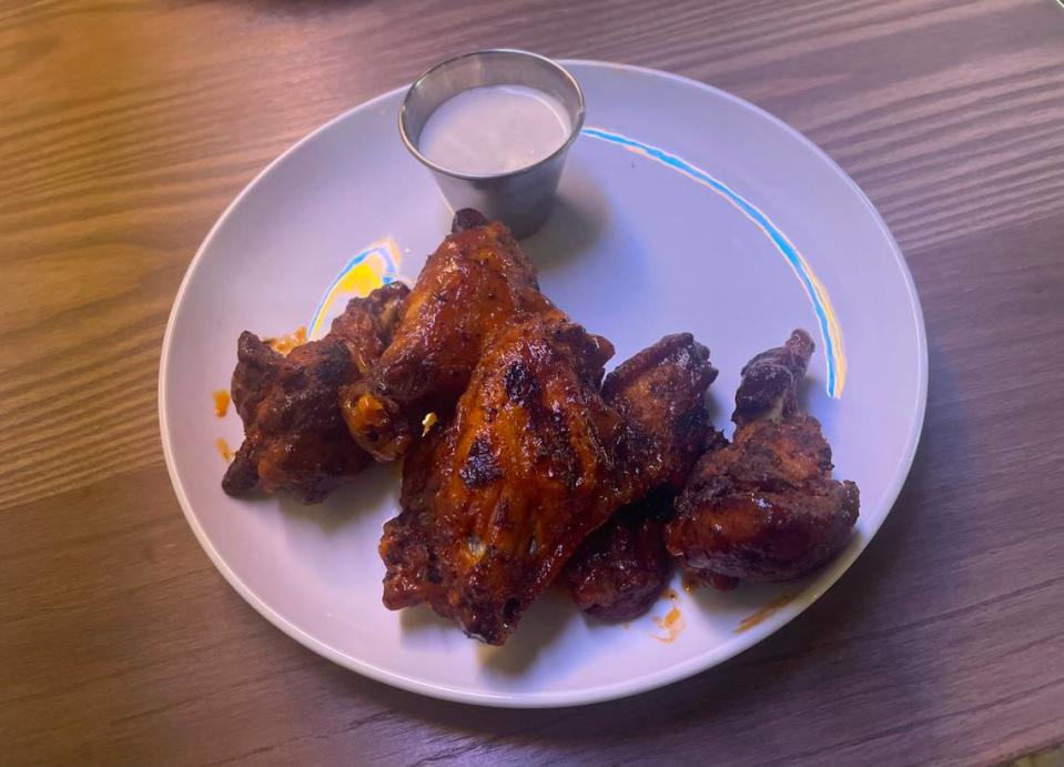 Smoked and charred buffalo wings, served with a side of buttermilk blue cheese, at Third Street Social.