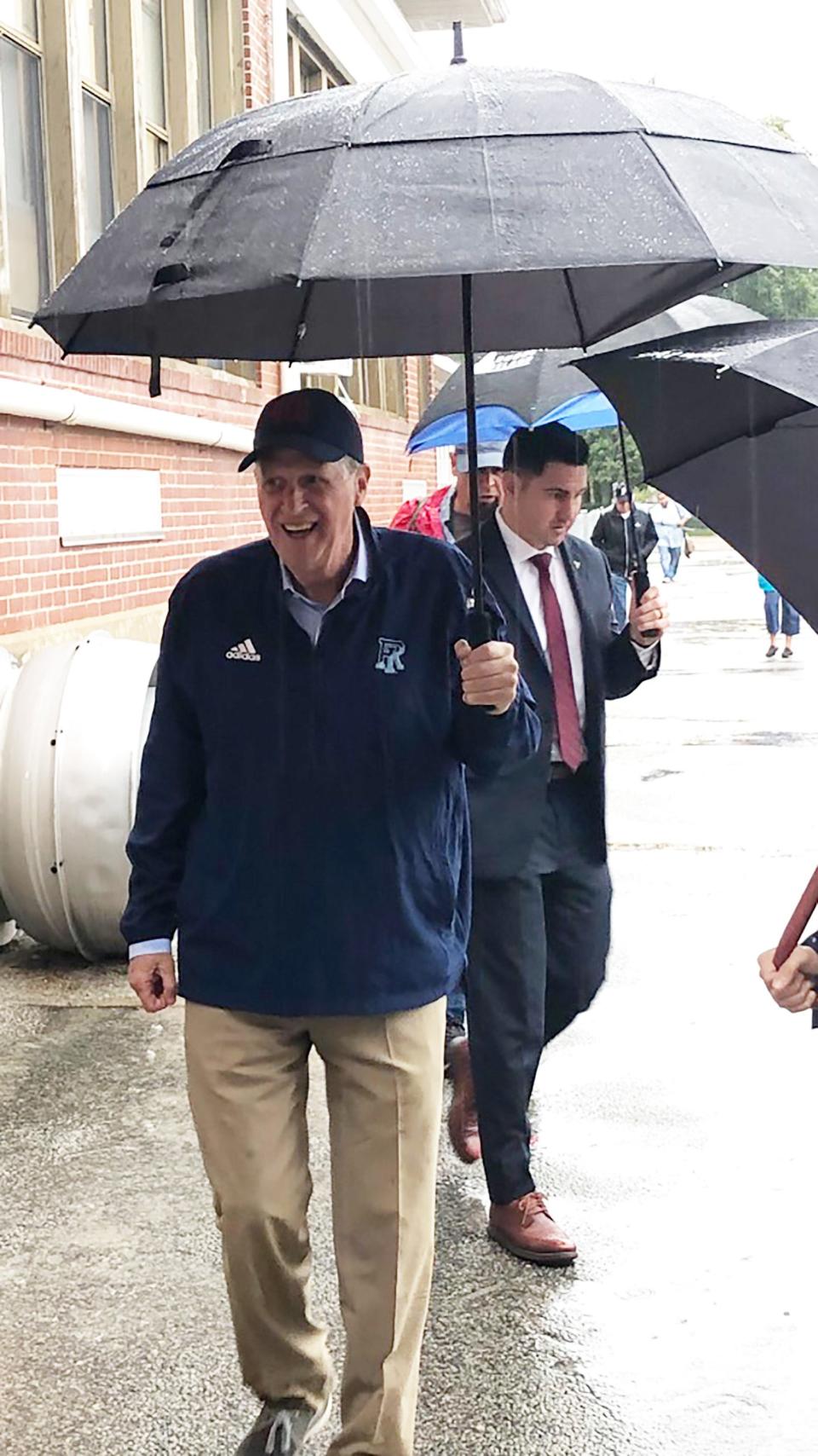 Governor McKee goes to vote in Cumberland Tuesday morning as the rain pours down.