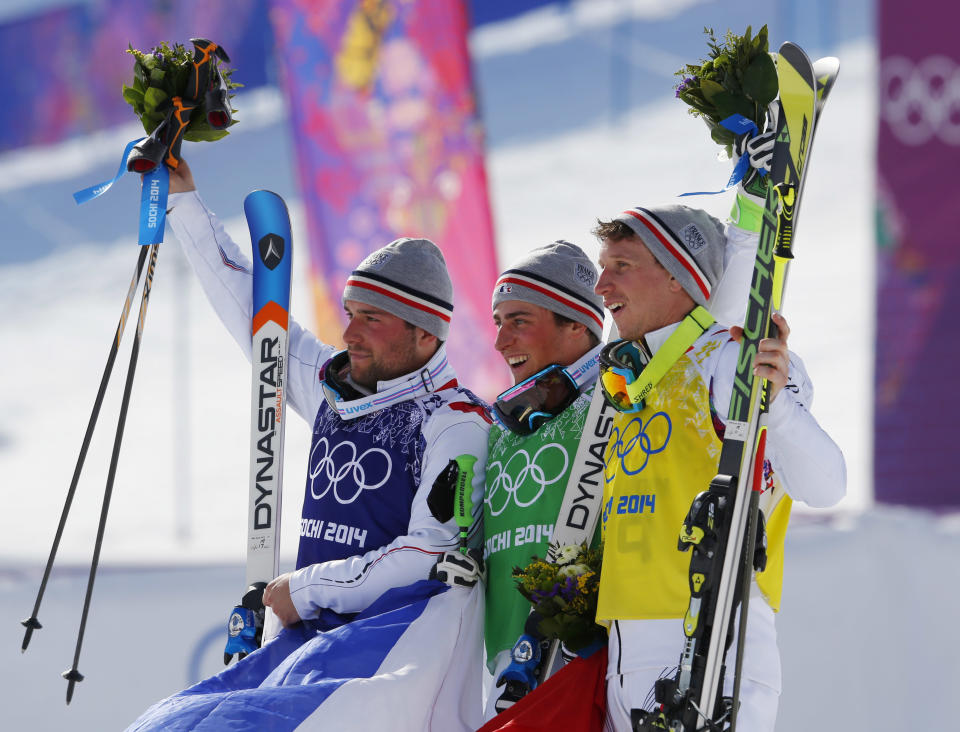 Men's ski cross gold medalist Jean Frederic Chapuis of France, center, celebrates with silver medalist Arnaud Bovolenta of France, left, and bronze medalist Jonathan Midol of France, at the Rosa Khutor Extreme Park, at the 2014 Winter Olympics, Thursday, Feb. 20, 2014, in Krasnaya Polyana, Russia. (AP Photo/Sergei Grits)