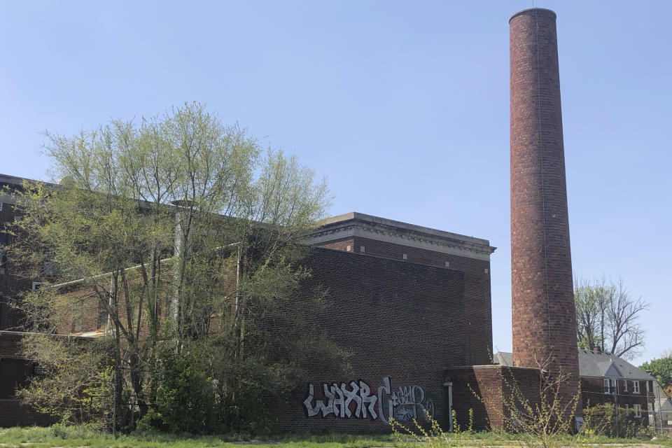 The abandoned Ford School in Highland Park, Mich., is seen on May 9, 2023. The school is one of the many abandoned buildings in the small Detroit enclave. In 1907, Ford Motor Co. founder Henry Ford bought 160 acres of land for what would be his Highland Park Ford Plant. More than 50,000 people lived in Highland Park in 1930. Fewer than 9,000 now call it home. The city is considering chapter 9 bankruptcy due to a $20 million debt owed to a regional water authority. (AP Photo/Corey Williams)