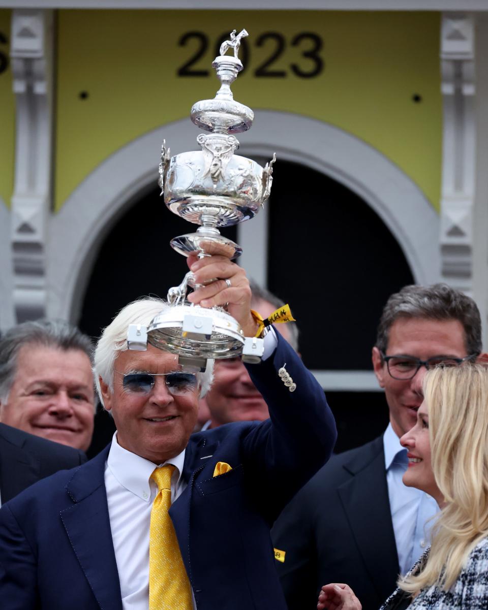 A man holding a trophy