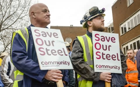 Workers stand with signs at Tata steel works on April 1, 2016 in Port Talbot, Wales.  - Credit: Getty