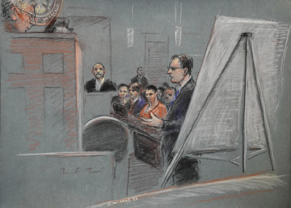 In this artist depiction, Massachusetts Air National Guardsman Jack Teixeira, center, is seated as defense attorney Brendan Kelley stands and speaks, at right, and his father Jack Michael Teixeira is seated in the witness stand, during a detention hearing in federal court, Thursday, April 27, 2023, in Worcester, Mass. Magistrate Judge David Hennessy in Teixeira's detention hearing put off an immediate decision on whether he should be kept in custody until his trial or released to home confinement or under other conditions. (Margaret Small via AP)