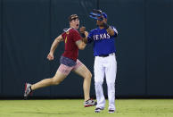 A fan runs across the field past Leonys Martin #2 of the Texas Rangers in the top of the eighth inning at Globe Life Park in Arlington on July 11, 2015 in Arlington, Texas. (Photo by Tom Pennington/Getty Images)