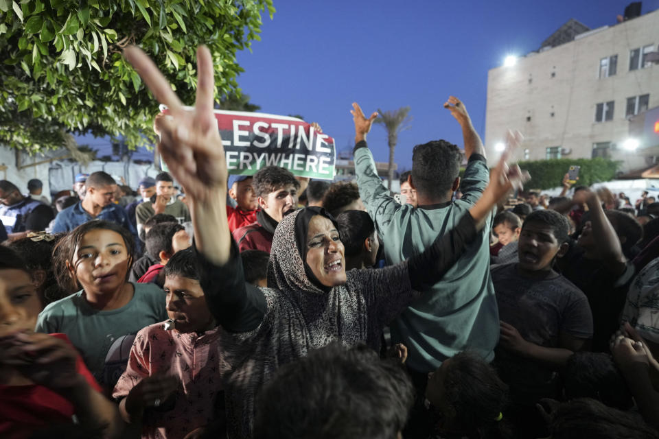 Palestinians celebrate in the streets following Hamas's announcement that it accepted a cease-fire proposal in Deir al-Balah, Gaza Strip on Monday, May 6, 2024. Despite the Hamas announcement, Israel said later Monday it would move forward with its planned offensive on Rafah, in the south of the strip. (AP Photo/Abdel Kareem Hana)