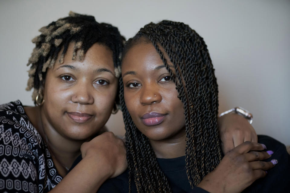 Sisters Angelica Lyons, left, and Ansonia Lyons pose for a portrait at their parents' home in Birmingham, Ala., on Saturday, Feb. 5, 2022. As a public health instructor, Angelica taught college students about racial health disparities, including the fact that Black women in the U.S. are nearly three times more likely to die during pregnancy or delivery than any other race. Then, in 2019, it nearly happened to her. Ansonia also had several difficulties when she became pregnant in 2020. (AP Photo/Wong Maye-E)