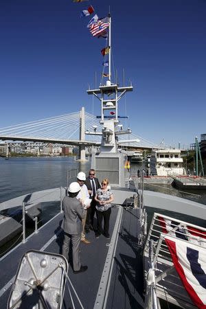 Visitors stand on the deck of the autonomous ship "Sea Hunter", developed by DARPA, docked in Portland, Oregon after its christening ceremony April 7, 2016. REUTERS/Steve Dipaola