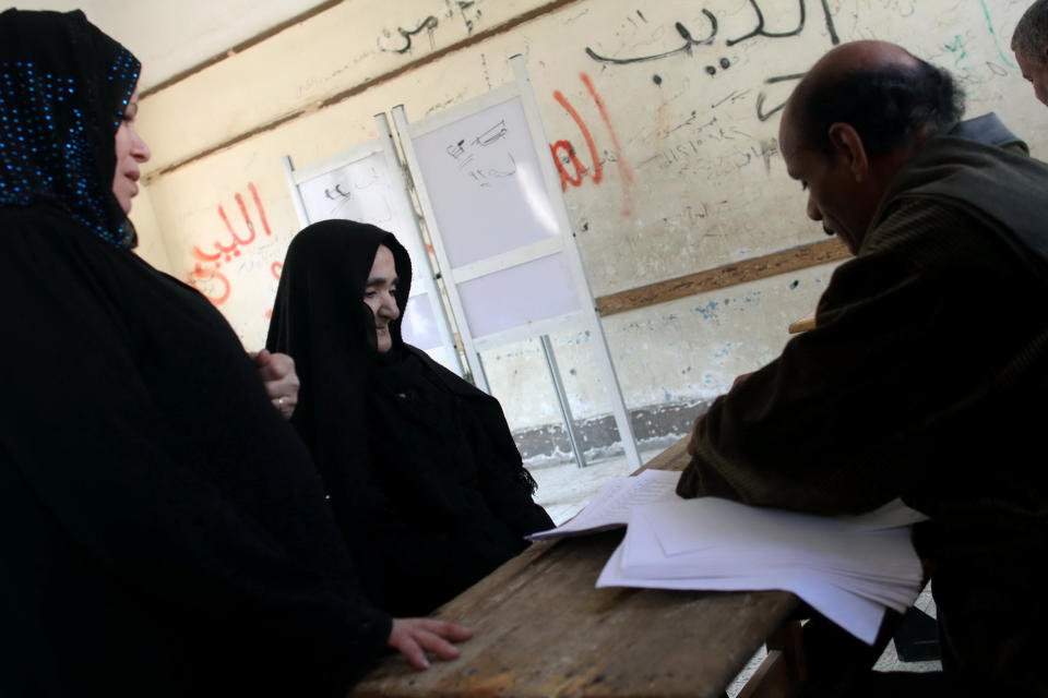 Christian voters check in before casting their ballots in the constitutional referendum inside a polling station in Dalga village of Minya, Egypt, Wednesday, Jan. 15, 2014. Through violence or intimidation, Islamists in villages like this one used violence or intimidation to stop Christians from voting "no" to a 2012 constitution that had paved the way for the creation of an Islamic state. This time around, no one is stopping the Christians and they are voting "yes" on a new charter that criminalizes discrimination and instructs the next legislature to ease restrictions on building churches. (AP Photo/Roger Anis, El Shorouk Newspaper) EGYPT OUT