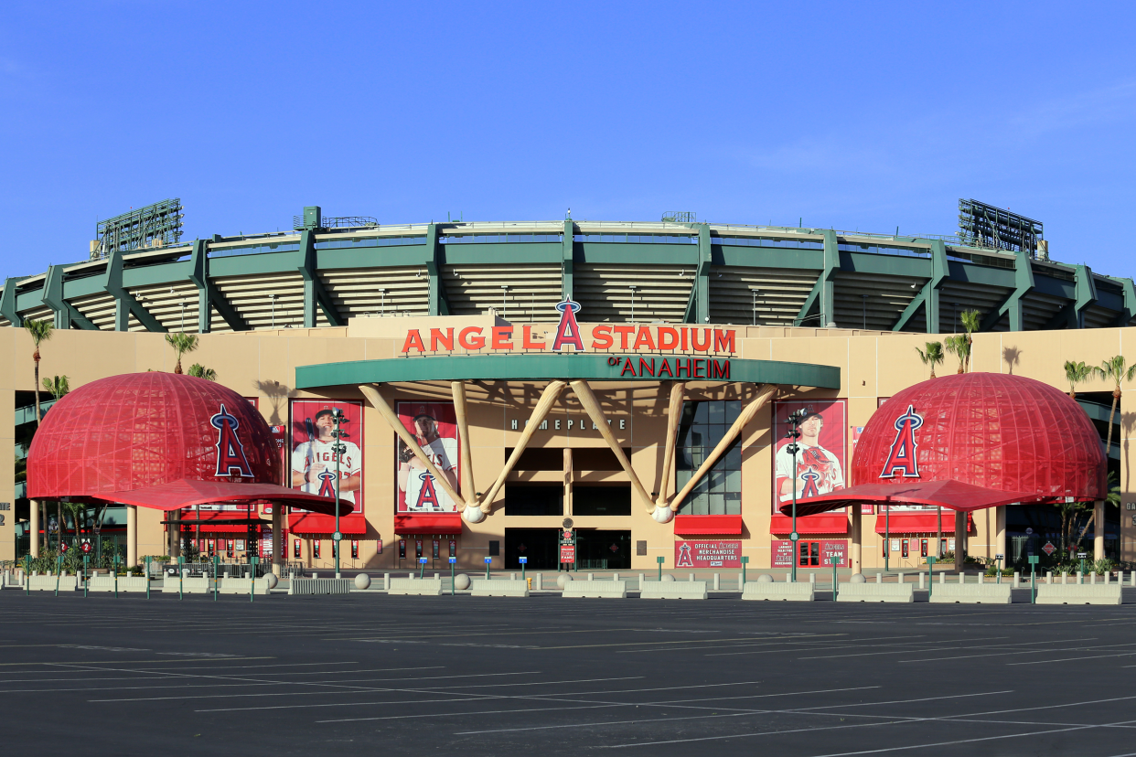 Exterior front of Angel Stadium, Anaheim, California, home of the Los Angeles Angels with an empty parking lot with a clear, blue sky