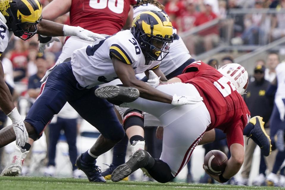 Michigan's Daxton Hill hits Wisconsin's Graham Mertz during the second half of an NCAA college football game Saturday, Oct. 2, 2021, in Madison, Wis. Mertz was hurt on the play and left the game. (AP Photo/Morry Gash)