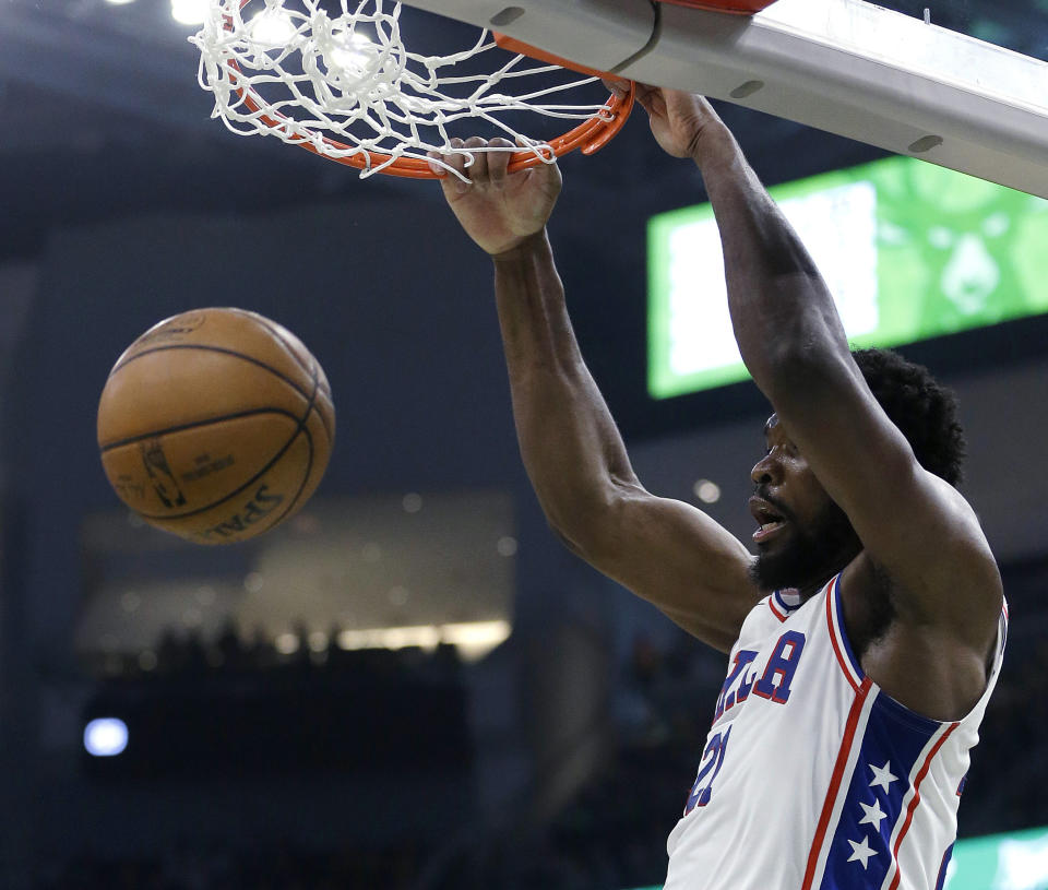 Philadelphia 76ers' Joel Embiid dunks during the first half of the team's NBA basketball game against the Milwaukee Bucks on Sunday, March 17, 2019, in Milwaukee. (AP Photo/Aaron Gash)