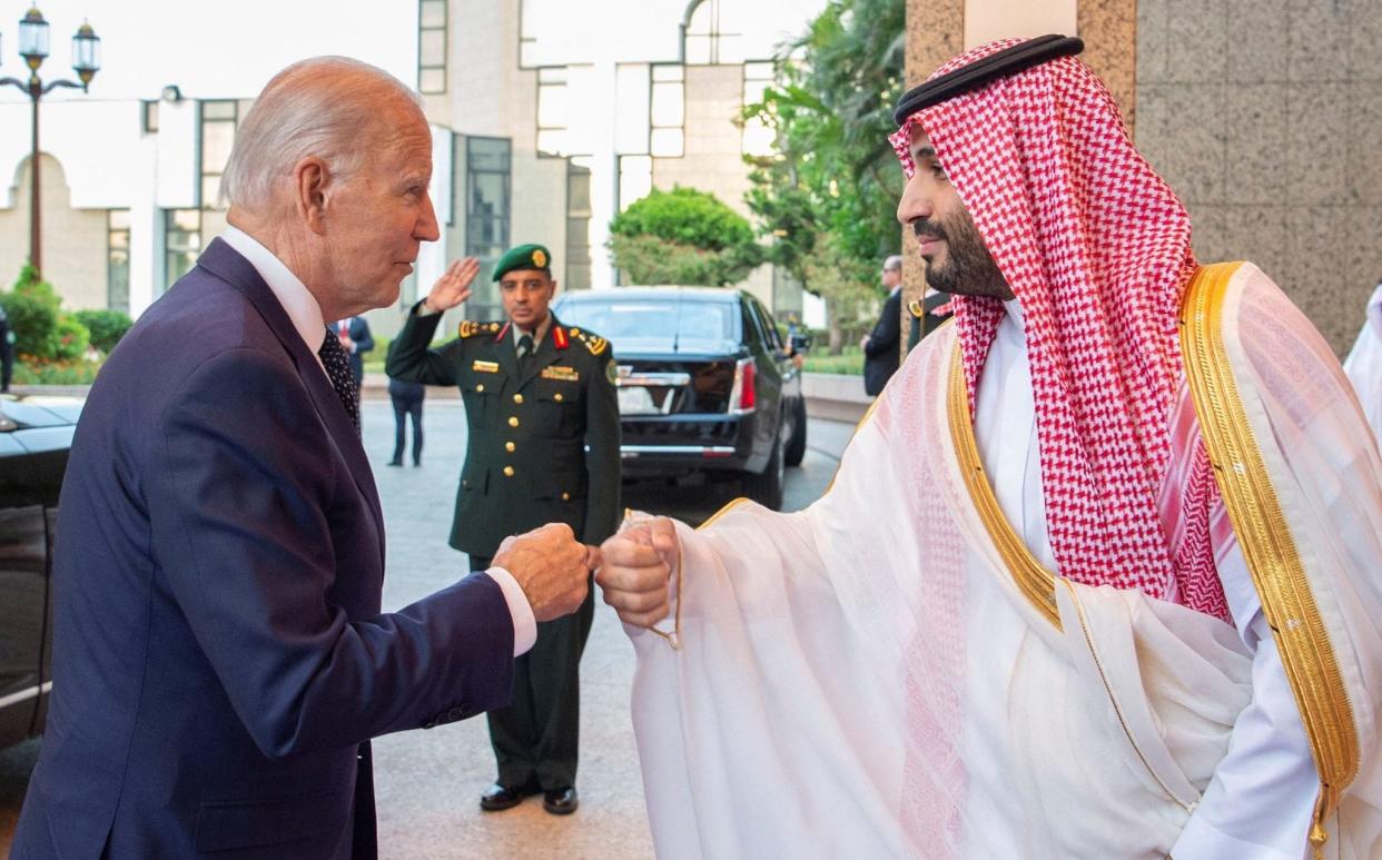 Saudi Crown Prince Mohammed bin Salman fist bumps US President Joe Biden upon his arrival at Al Salman Palace, in Jeddah
