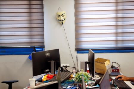 A Guy Fawkes mask made popular by the movie "V for Vendetta", hangs on a wall in an office at Cybergym, a cyber-warfare training facility backed by the Israel Electric Corporation, in Hadera, Israel