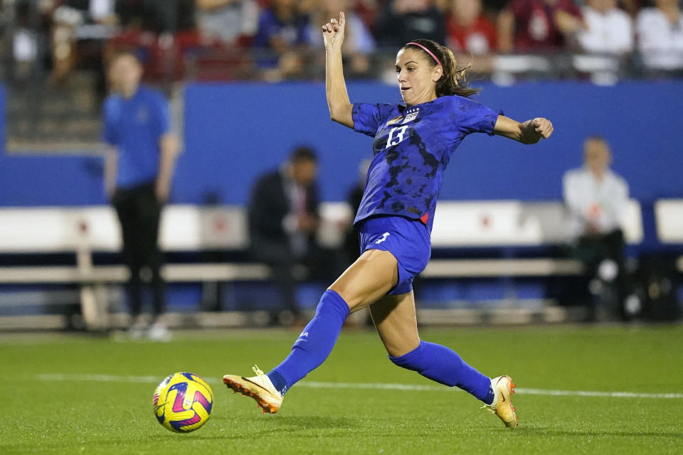 FILE - United States forward Alex Morgan (13) reaches to control the ball during the first half of a SheBelieves Cup soccer match against Brazil Wednesday, Feb. 22, 2023, in Frisco, Texas. Morgan says she feels calmer heading into this World Cup and wants to represent mom athletes. She's one of three mothers on this U.S. squad and is often accompanied by 3-year-old daughter Charlie. (AP Photo/LM Otero, File)