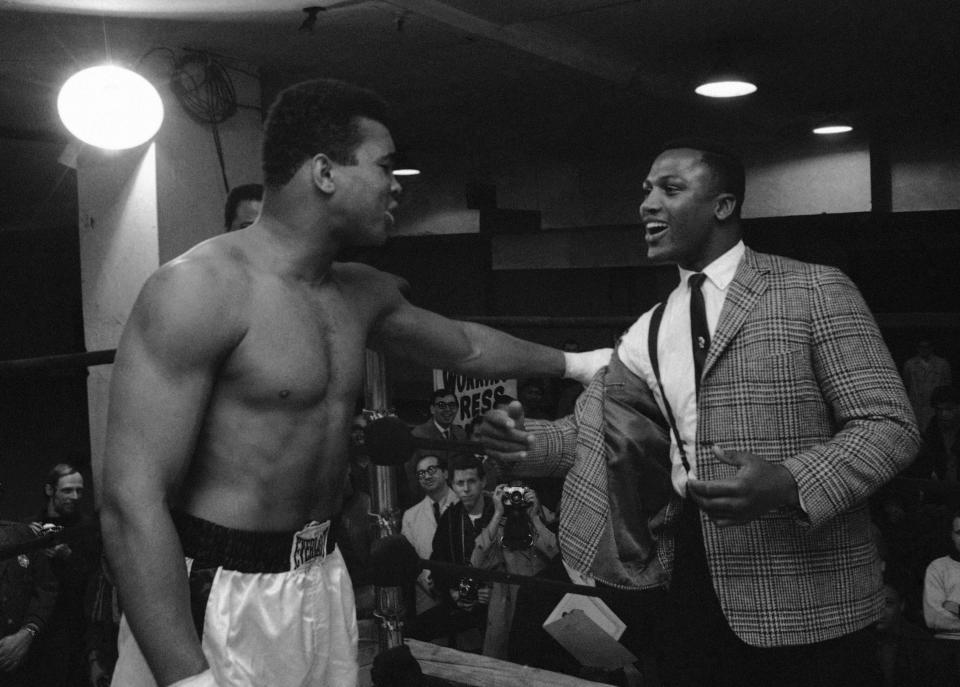 FILE - In this March 15, 1967, file photo, Joe Frazier, right, a heavyweight boxer and a contender for champion Muhammad Ali's (Cassius Clay) title, is kidded by Clay at the champion's training quarters at Madison Square Garden in New York. Frazier, the former heavyweight champion who handed Muhammad Ali his first defeat yet had to live forever in his shadow, died Monday Nov. 7, 2011, after a brief final fight with liver cancer. He was 67. (AP Photo/John Rooney, File)
