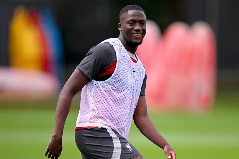 Ibrahima Konate smiles during a Liverpool training session