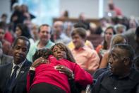 <p>School president Donna Harris hugs ninth-grader Alexis Stanley as she arrives at a prayer service at the Minnehaha Academy Lower School on Aug. 2, 2017, in Minneapolis, Minn. Firefighters were searching for a man believed to be buried in the rubble of the collapsed school building in Minneapolis on Wednesday after an explosion killed another school employee and injured several others. (Renee Jones Schneider /Star Tribune via AP) </p>