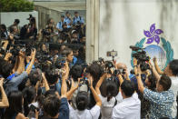 Member of the media surround Chung Pui-kuen, the ex-chief editor of the now shuttered Stand News online outlet, outside the district court, in Hong Kong on Thursday, Aug. 29, 2024. (AP Photo/Billy H.C. Kwok)