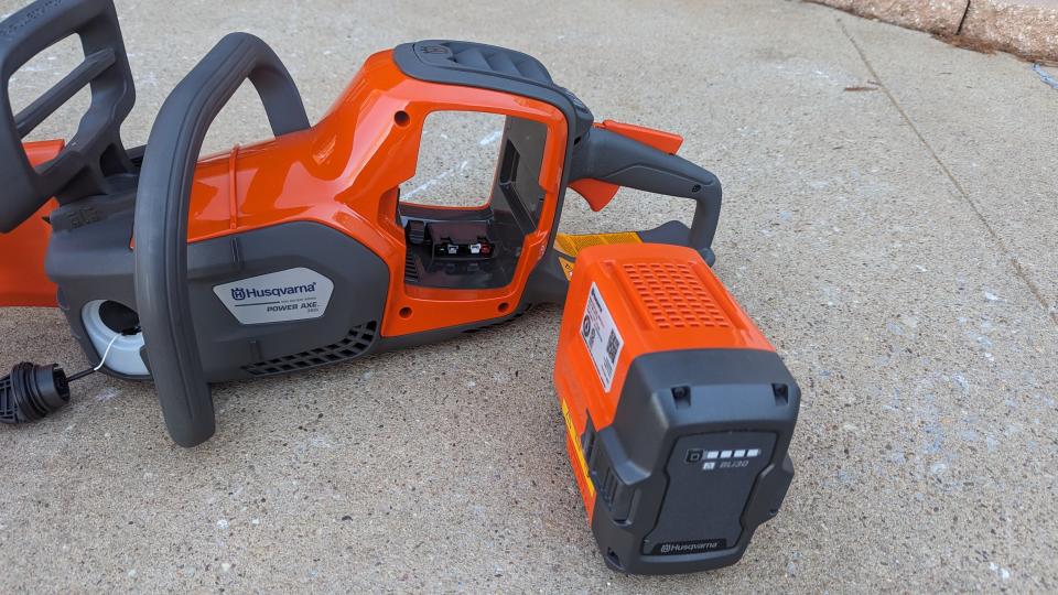 Image showing the battery and the port that it fits into on the chainsaw