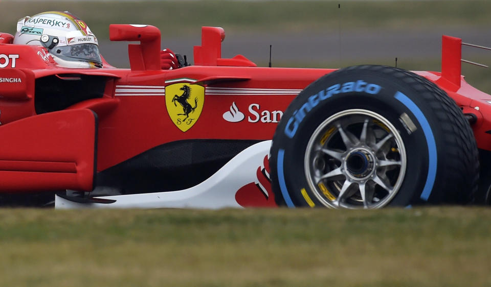 FILE - Sebastian Vettel steers the Ferrari Formula One SF70H racer at the Ferrari Fiorano private test track in Maranello, Italy, Feb. 24, 2017. Short-term rental giant Airbnb is listing 11 iconic locations, including a night at the Ferrari Museum in Maranello, in a splashy new marketing campaign. (AP Photo/Marco Vasini, File)