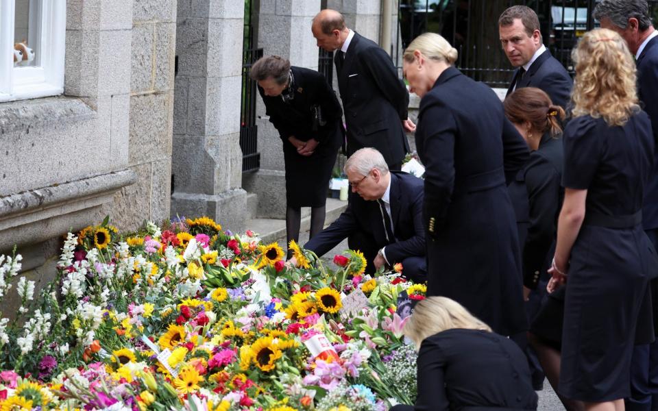 Prince Andrew inspects floral tributes left outside Balmoral Castle with his family - PHIL NOBLE/REUTERS