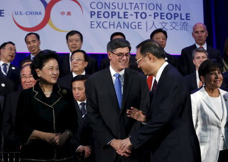 Chinese State Councilor Yang Jiechi (R) talks to U.S. Treasury Secretary Jack Lew before a family photo at the Strategic and Economic Dialogue (S&ED) at the State Department in Washington June 23, 2015. REUTERS/Yuri Gripas