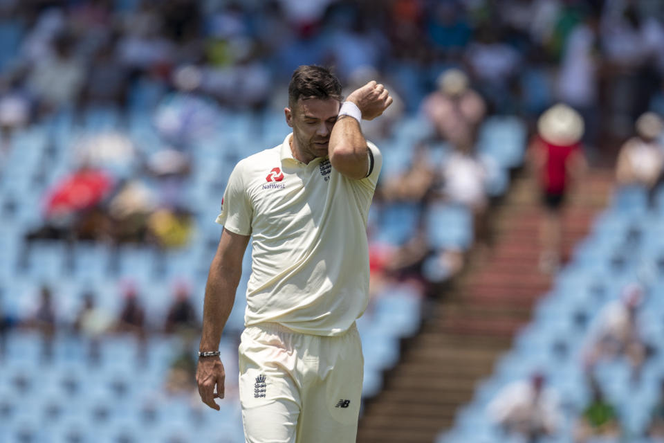 England's bowler James Anderson wipes his face after his delivery against South Africa's batsman Rassie van der Dussen on day one of the first cricket test match between South Africa and England at Centurion Park, Pretoria, South Africa, Thursday, Dec. 26, 2019. (AP Photo/Themba Hadebe)