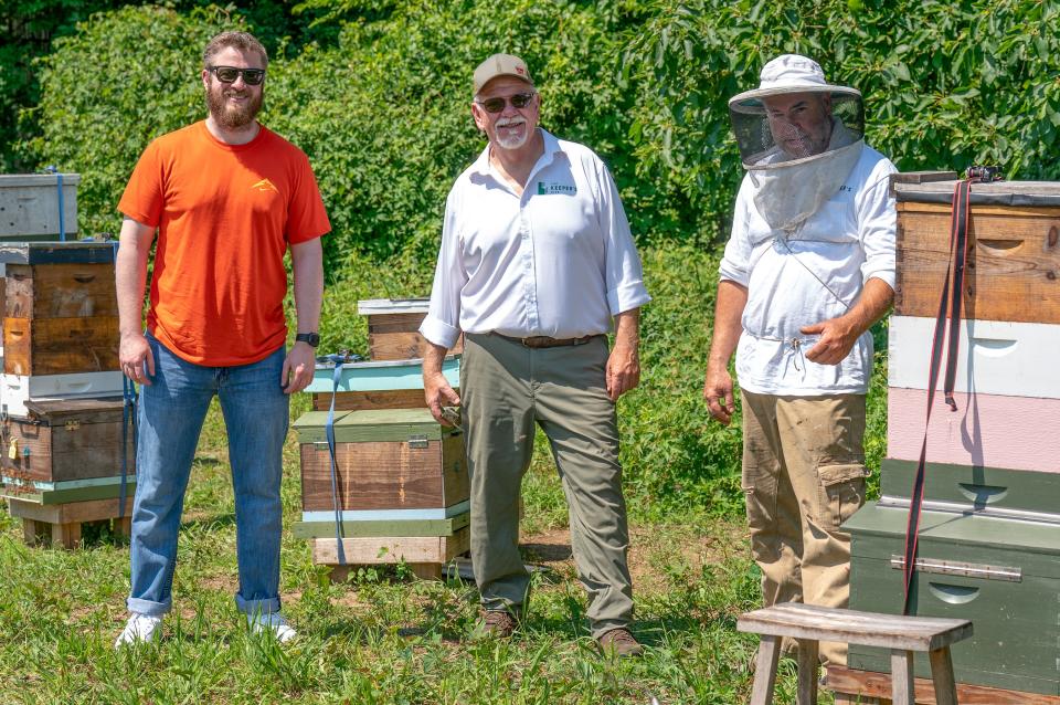 Dave McNeeley, left, stands for a photo with beekeepers Nat Wolfe, center, and George Datto, right, after they tended to 
the beehive at the Winterthur in Wilmington on Tuesday, June 18, 2024.