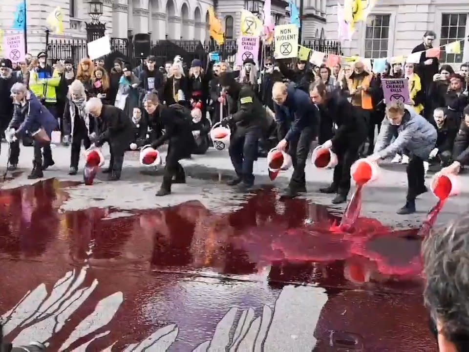 Climate change rebellion protesters pour fake blood on road outside Downing Street