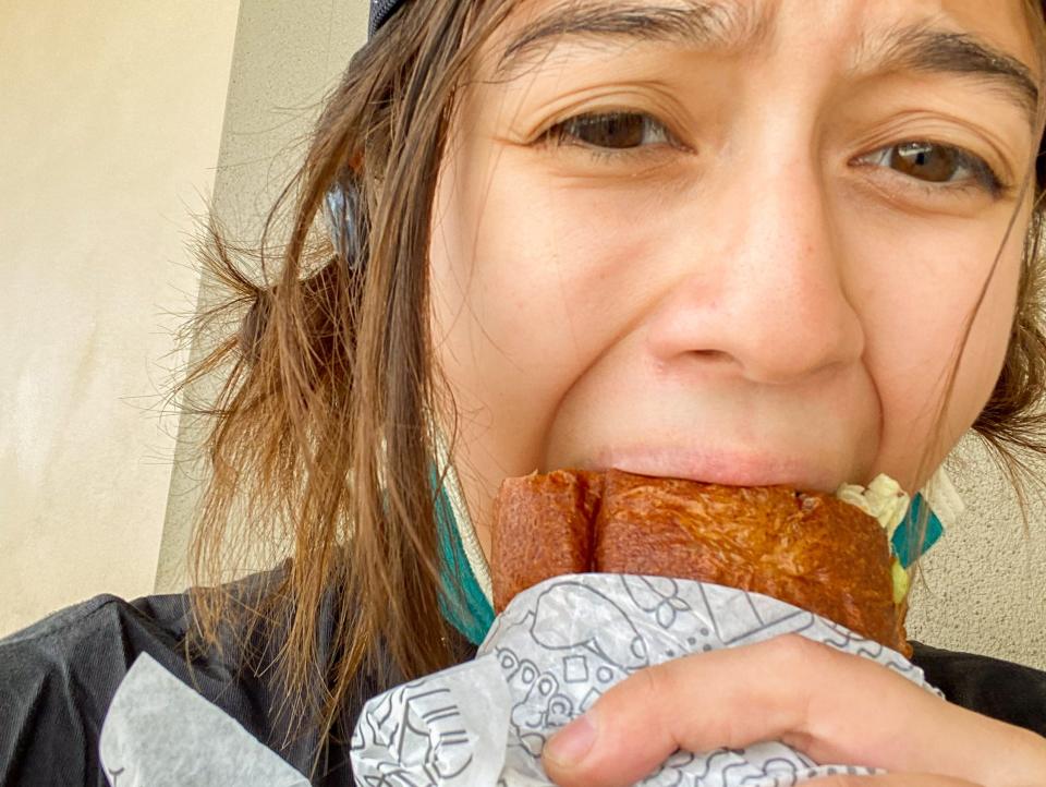 The author takes a bite of her Publix sub