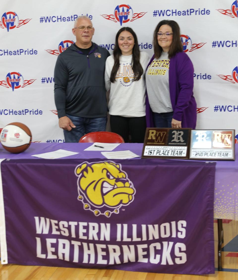 Shelby Bowman poses for a photo with her mom and dad after signing a letter of intent to play basketball at Western Illinois University.