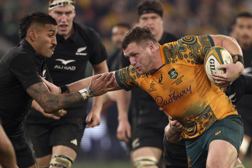 Australia's Angus Bell, right, fends off New Zealand's Rieko Ioane during their Bledisloe Cup rugby union test match in Melbourne, Australia, Saturday, July 29, 2023. (AP Photo/Hamish Blair)