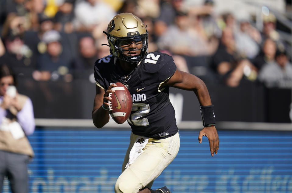 Colorado quarterback Brendon Lewis rolls out to make a pass against Arizona in the first half of an NCAA college football game Saturday, Oct. 16, 2021, in Boulder, Colo. (AP Photo/Geneva Heffernan)